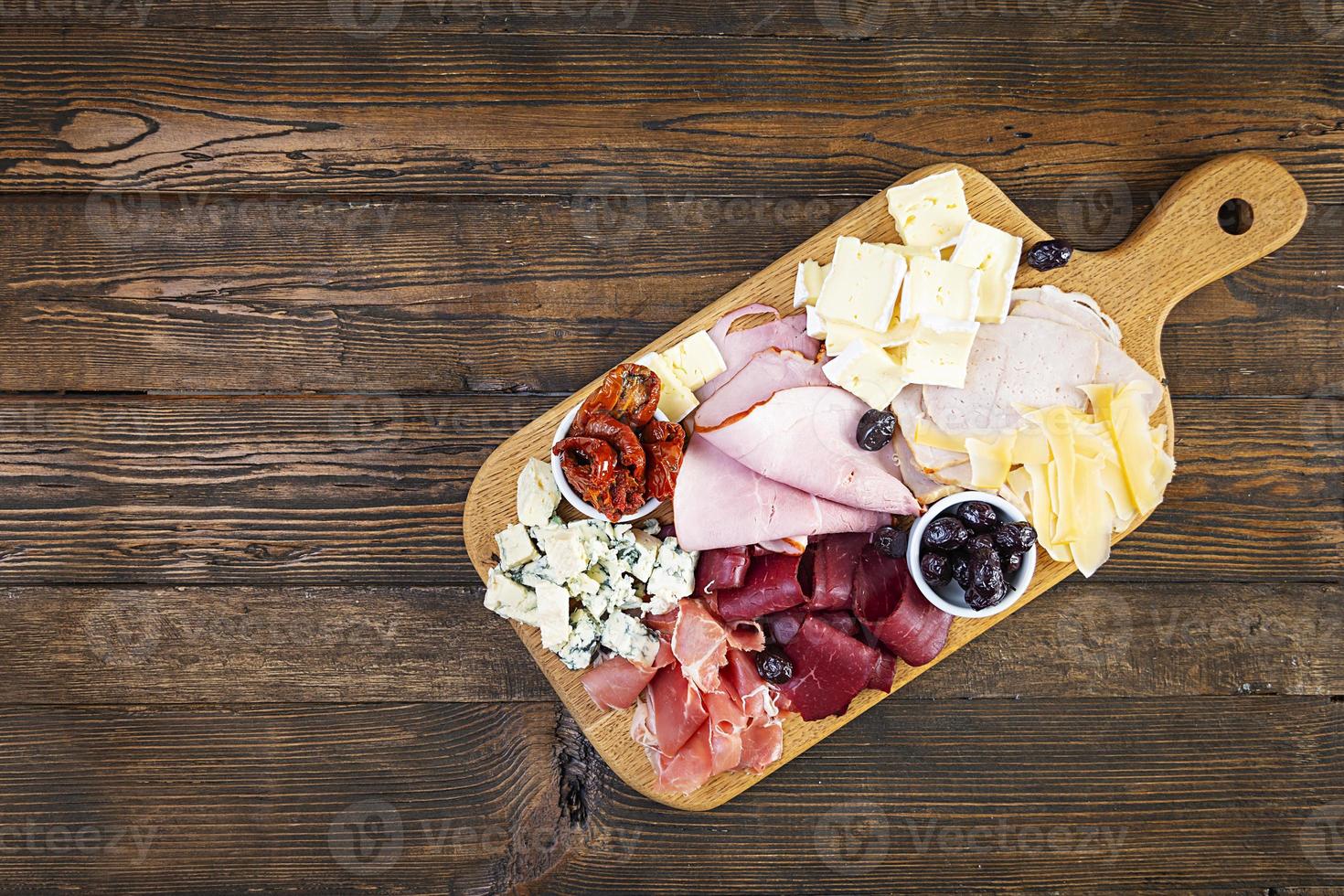 Italian antipasto. Antipasti board with ham, salsami, prosciutto, parmesan, blue cheese and