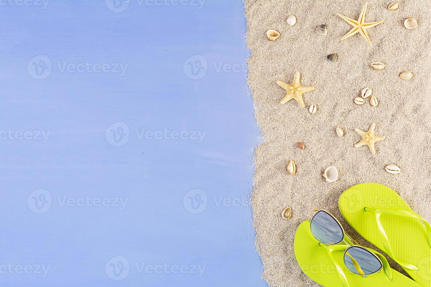 Summer background. Sea sand with seashells, starfish and sunglasses. Summer vacation concept photo