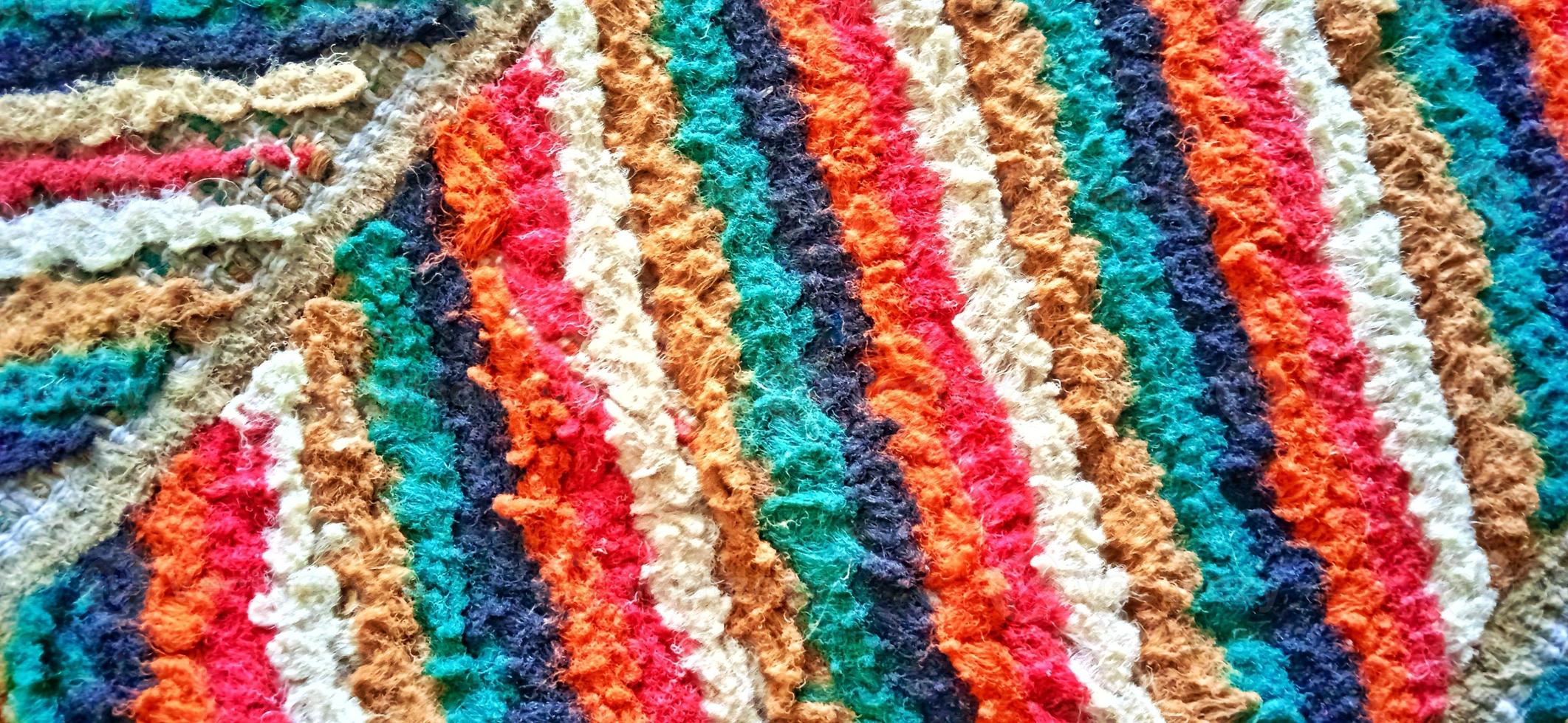 Variegated multicolor straight woven carpet texture. Fuzzy thin grunge vertical line textile material. Curly carpet rug fabric effect. photo