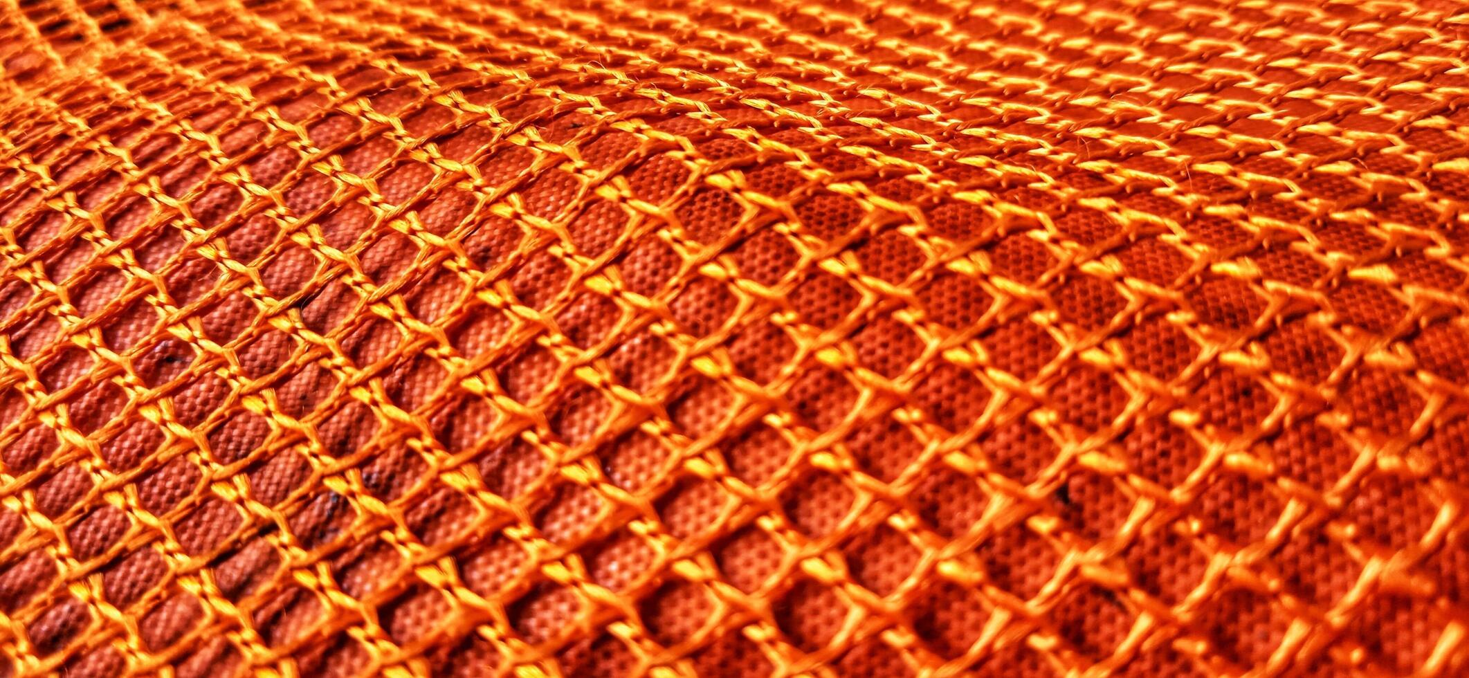 Gold orange honeycomb net patterns backgrpund. Synthetic honeycom net structure fabric background design. Available for text. Suitable for poster, backdrop, presentation, wallpaper, advertising, etc. photo