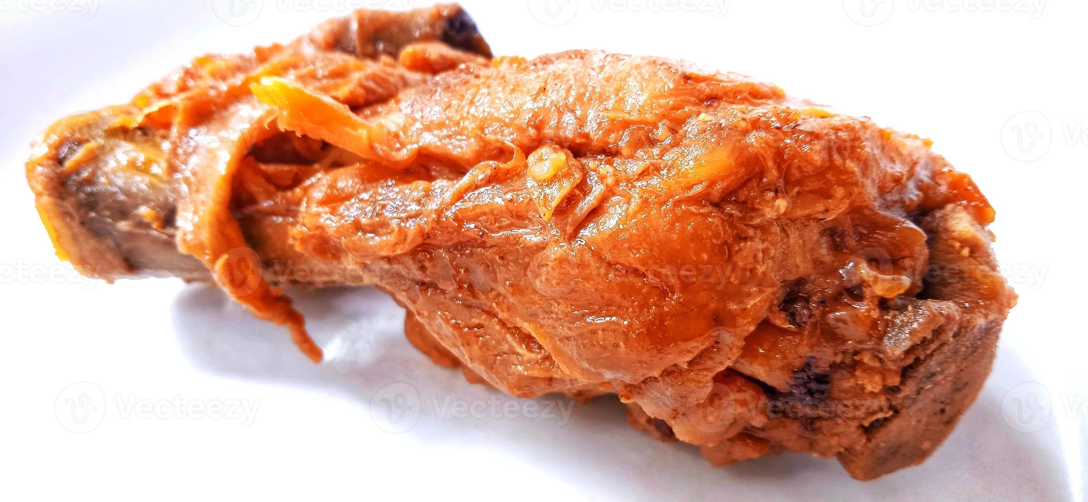 A brown chicken with sweet soy sauces under white gray plate background. Food ingredient background design. Suitable for advertising of food, drink, poster, backdrop, food company and industry. photo