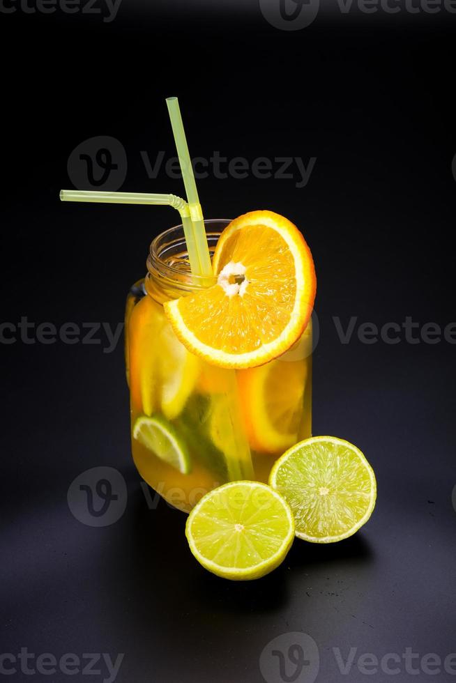 Homemade lemonade with orange and lime photo