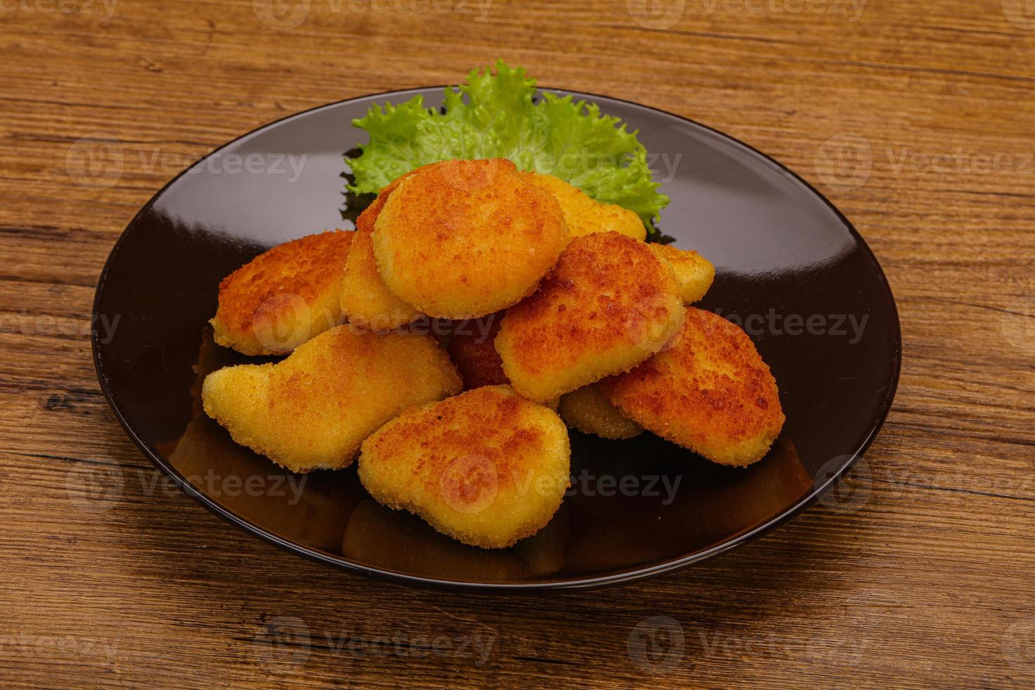 Fried chicken nuggets served salad leaves photo