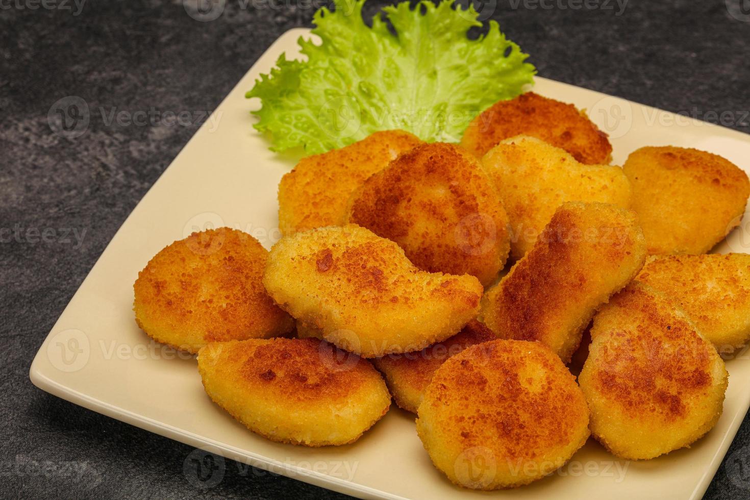 Fried chicken nuggets served salad leaves photo