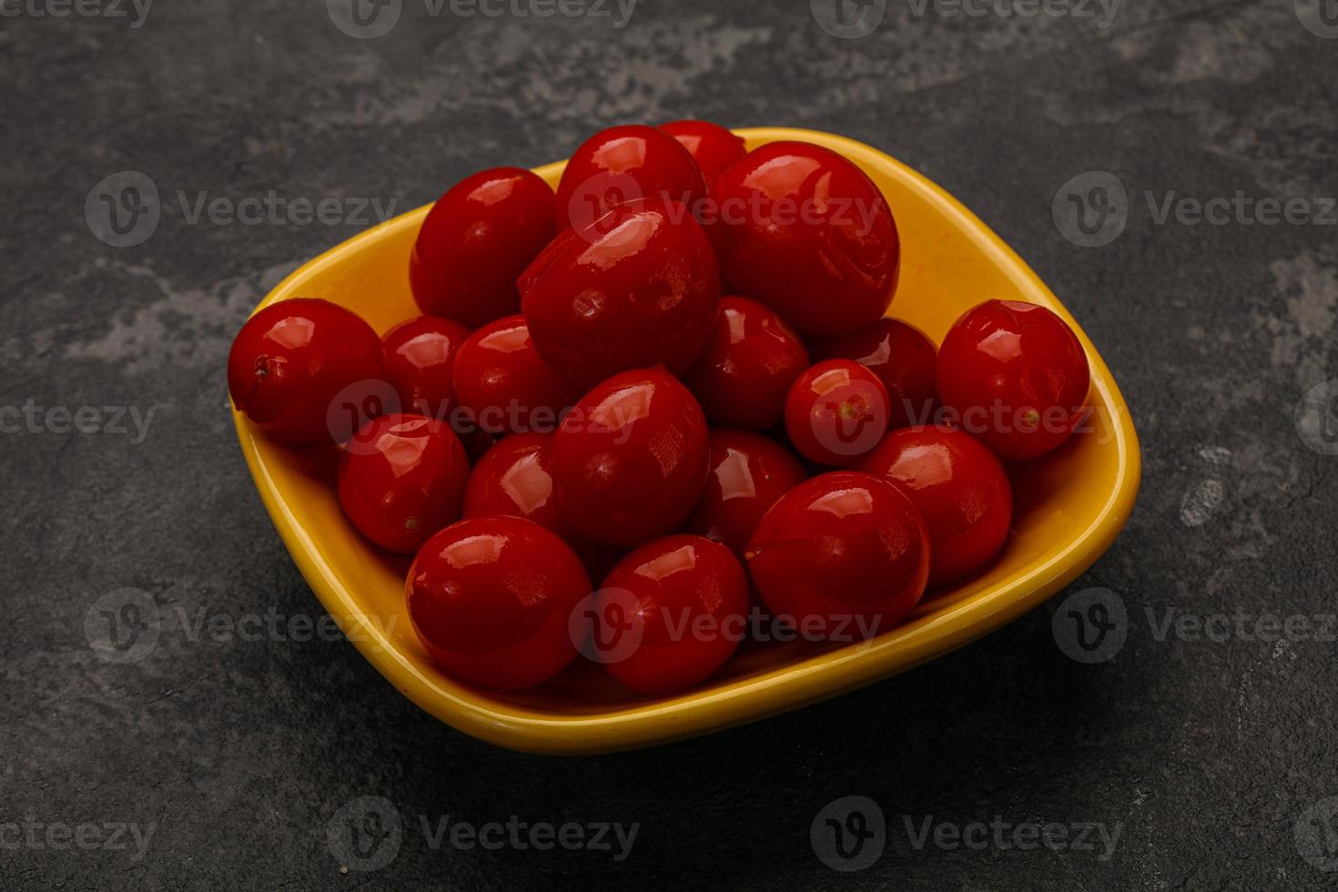 Pickled cherry tomatoes in the bowl photo