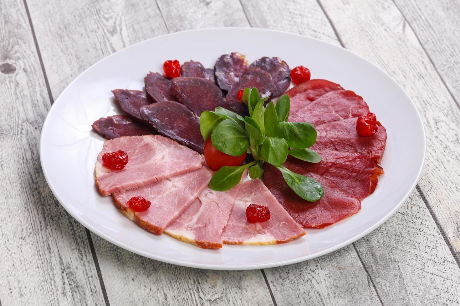Meat plate with horse, beef and chicken sausages photo