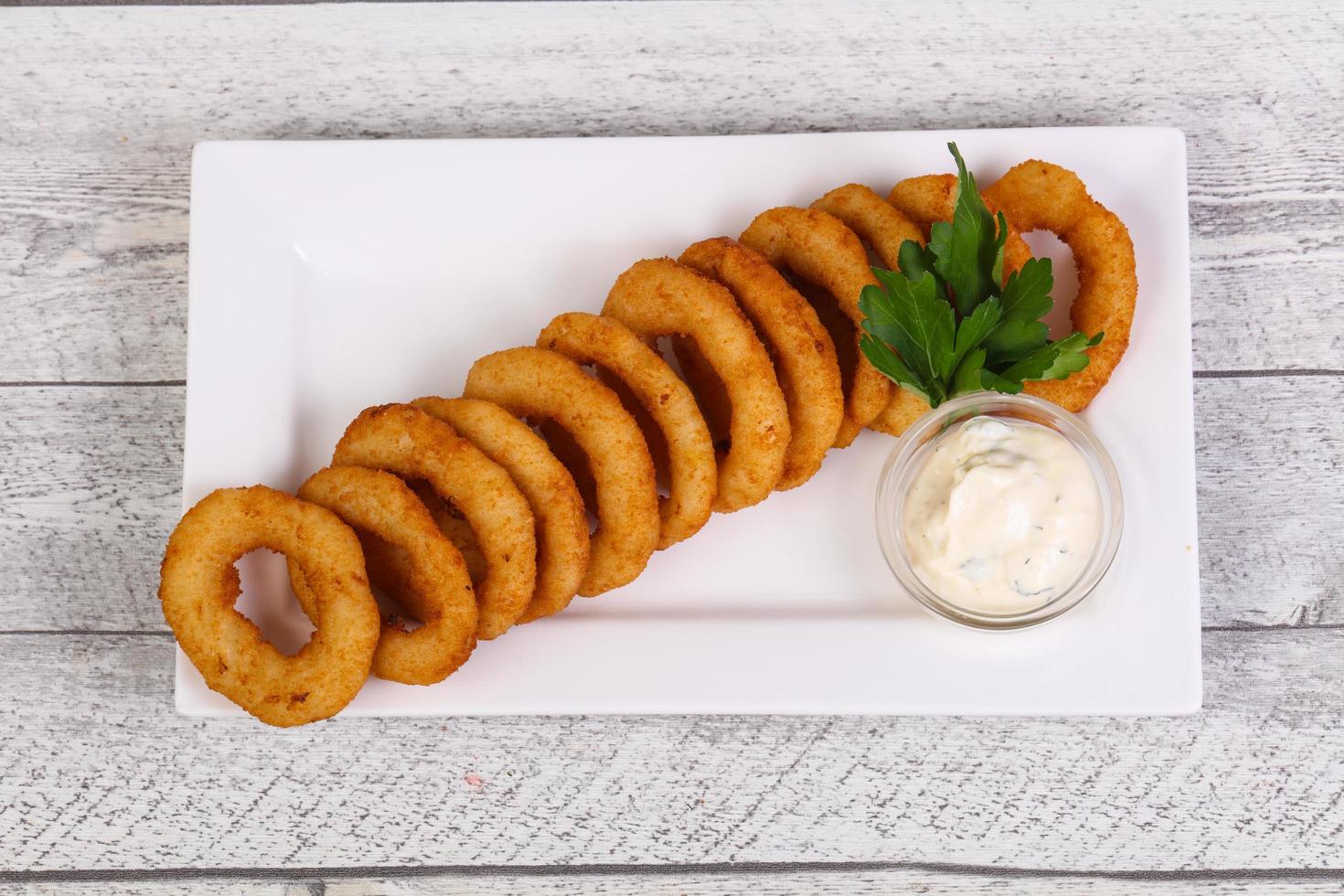 Squid rings snack with sauce photo