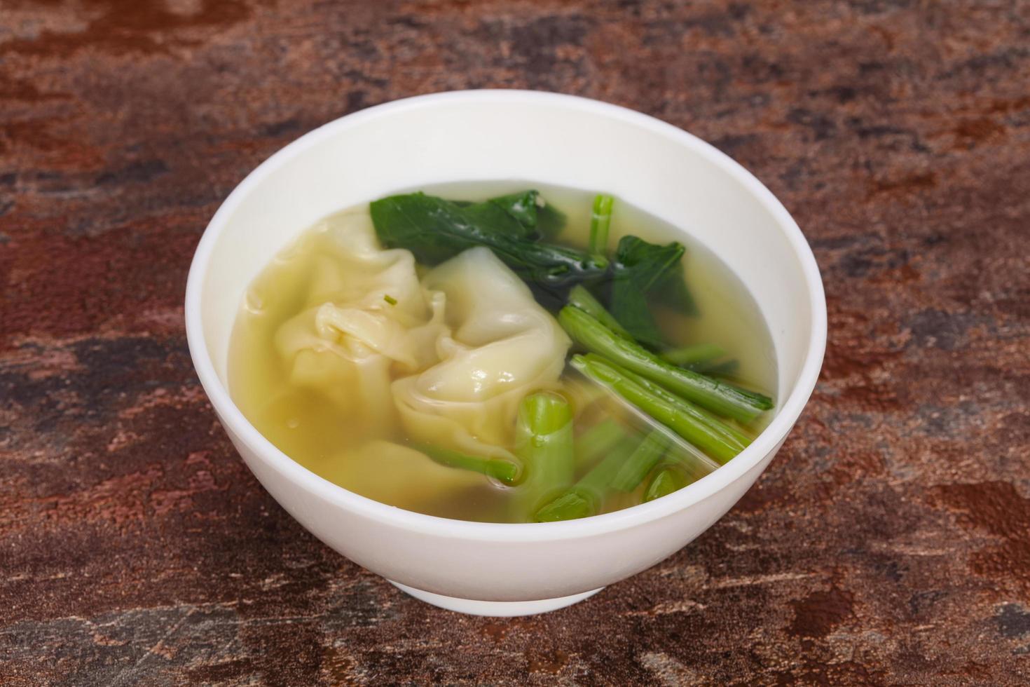 Asian traditional Wonton soup with herbs photo