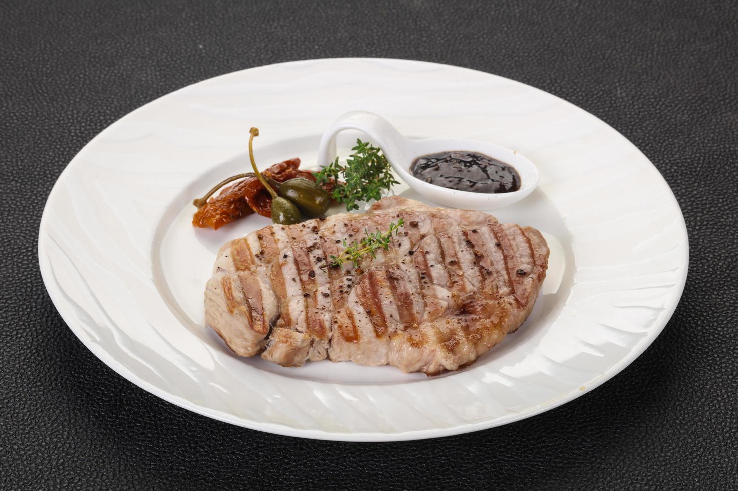 Grilled pork steak with pepper sauce photo