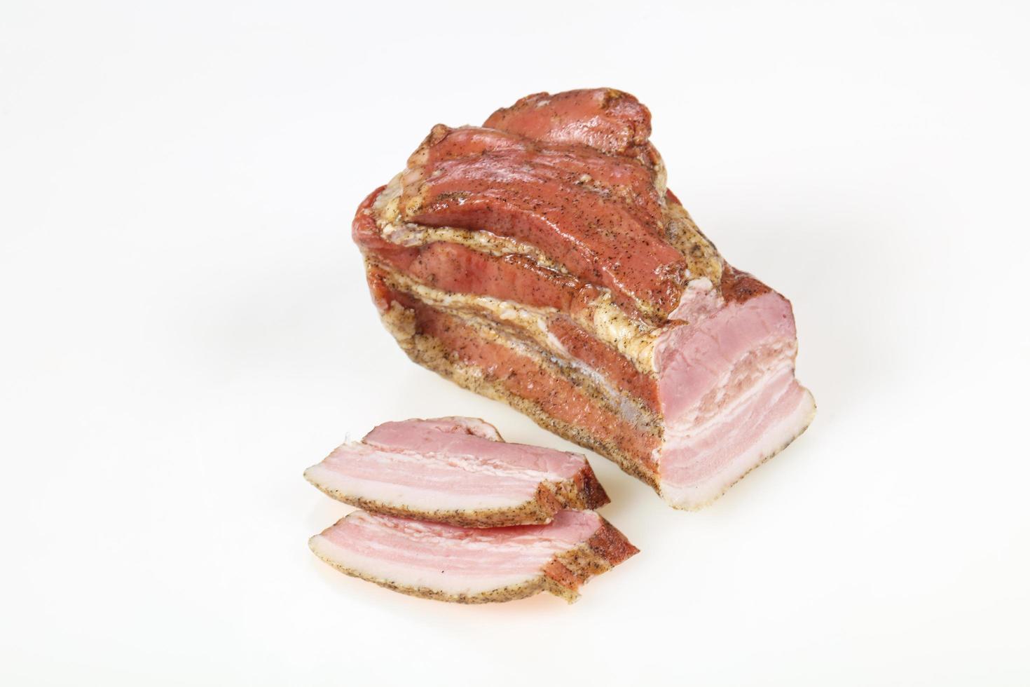 Smoked pork meat over white background photo