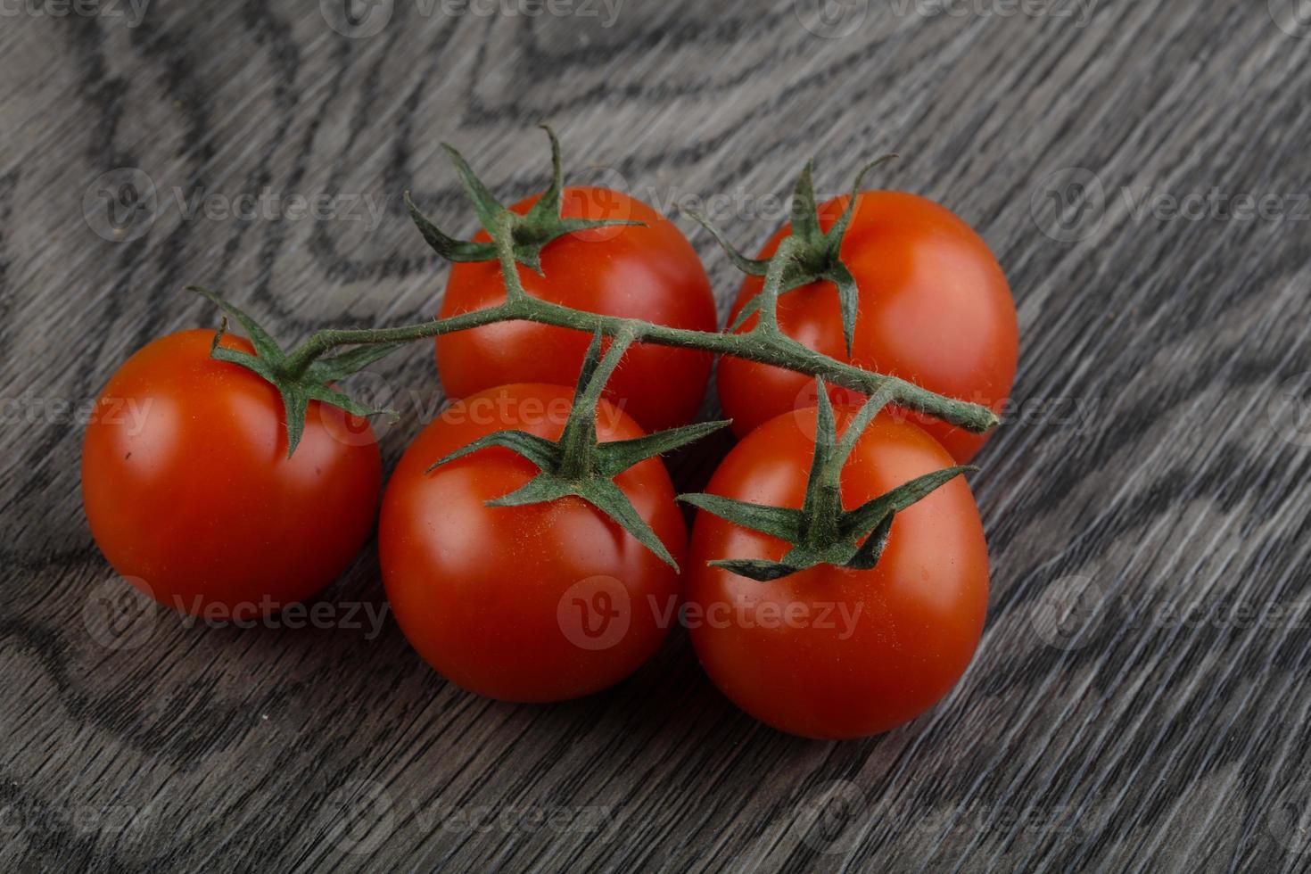 Cherry tomatoes on wood photo