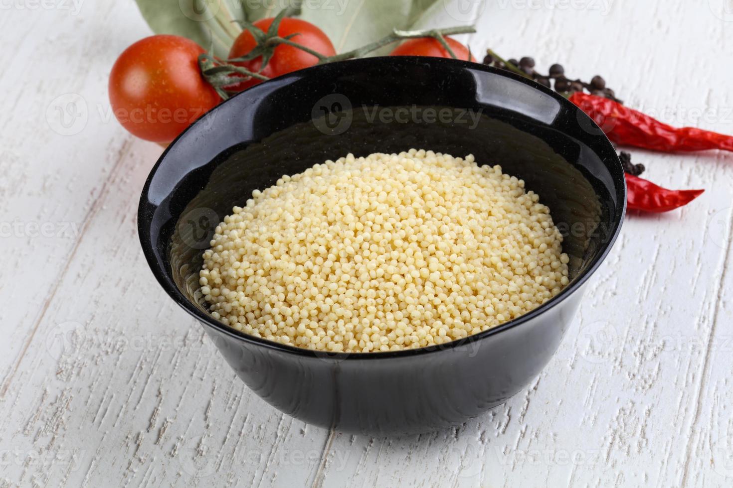 Raw millet in bowl photo