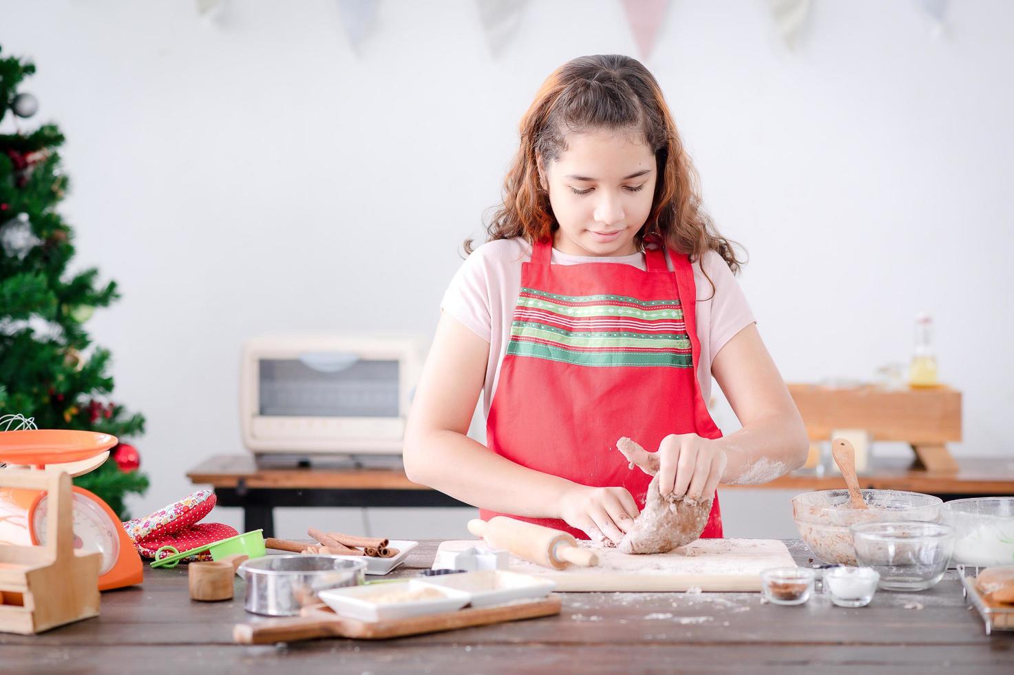 European girls prepare tools and ingredients for making gingerbread during Christmas and New Year celebrations photo