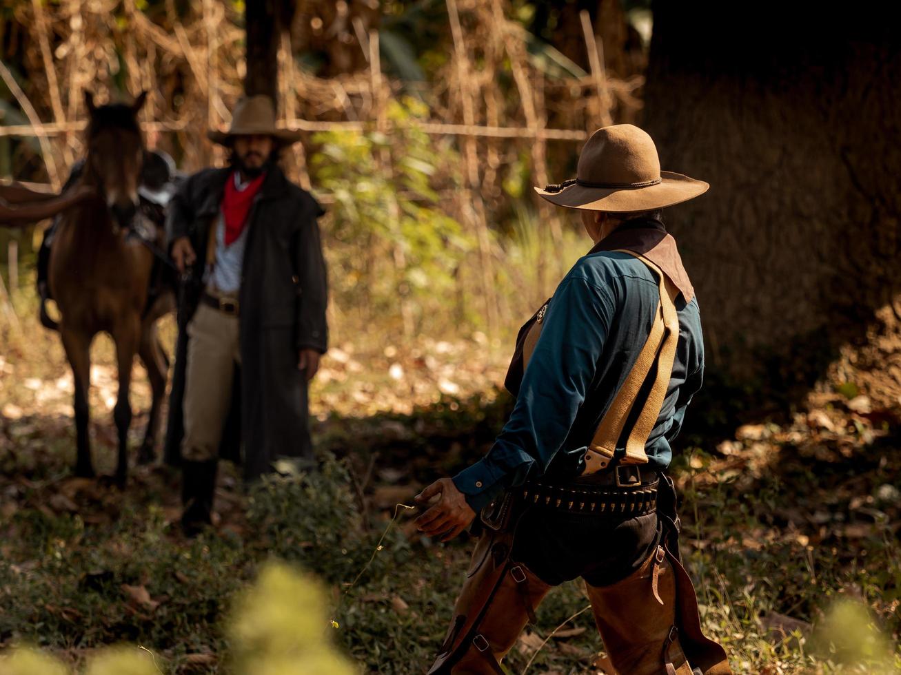 The senior cowboy stands preparing for a gunfight against opponents in the outlawed western lands photo