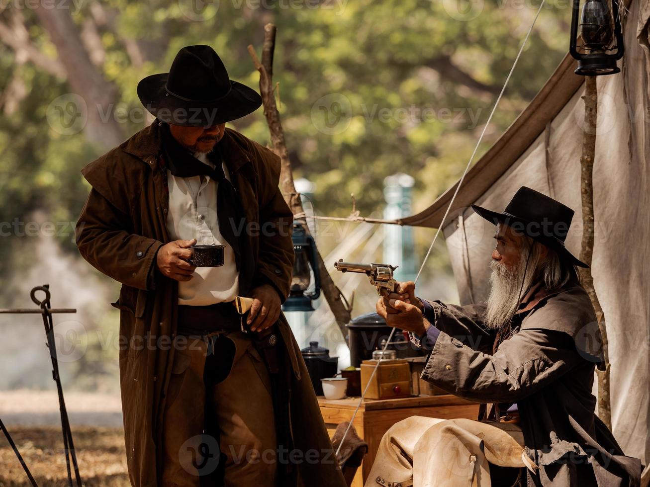 Twin senior cowboys are resting while protecting the safety of the camp in the western area photo