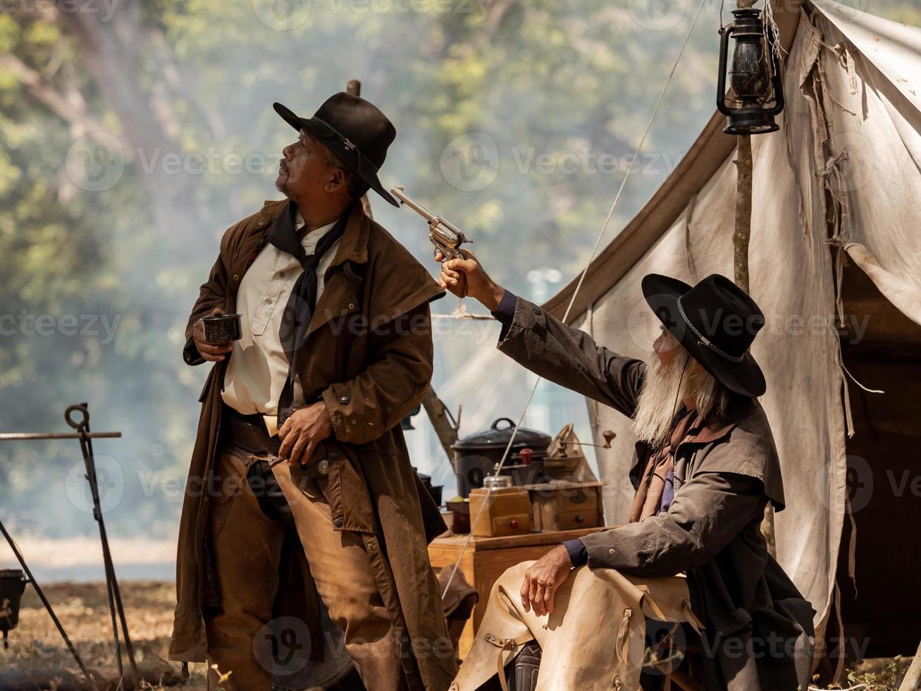 Twin senior cowboy are resting while protecting the safety of the camp in the western area photo