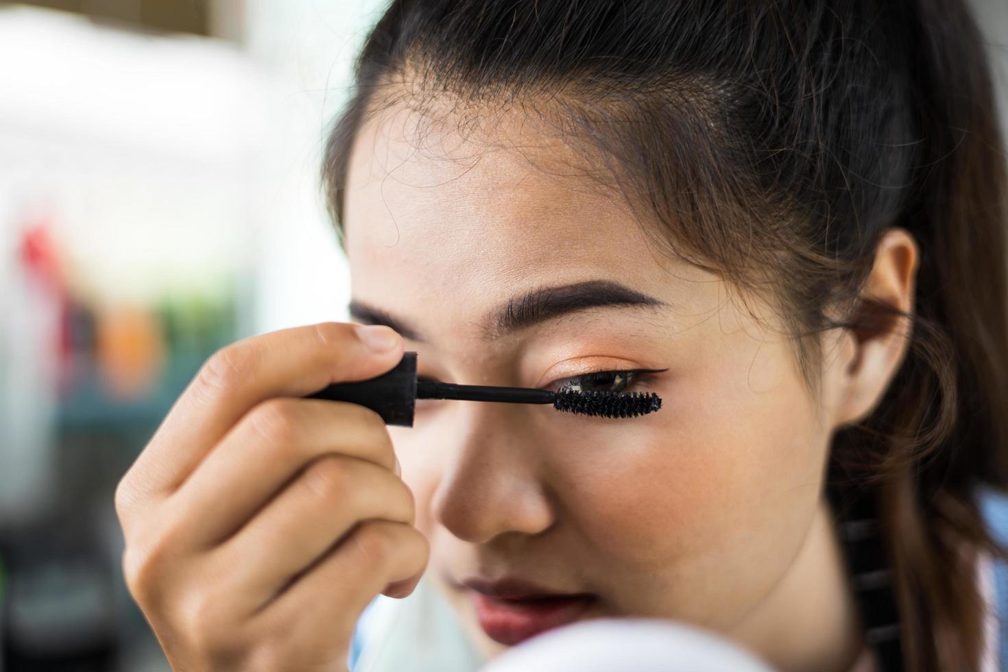 Close-up portrait of a beautiful woman face curling eyelashes. photo