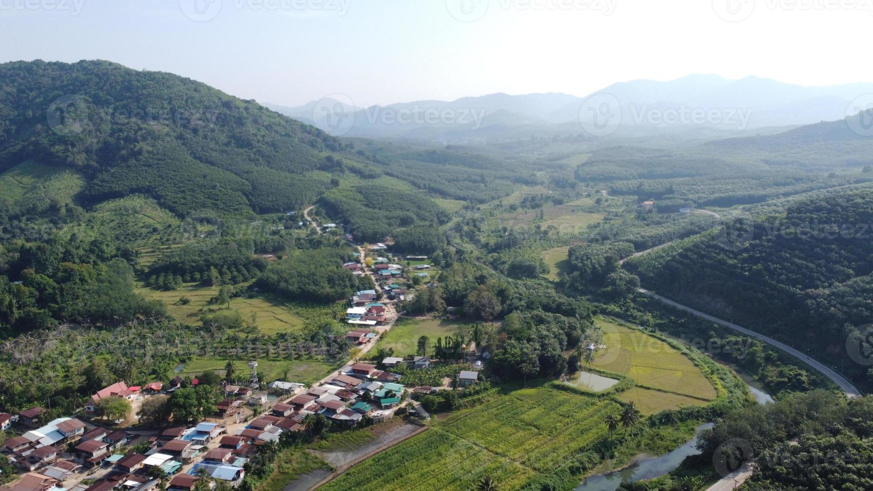 Drone point of view. Songkrom landscape in springtime. Patchwork landscape with single lane winding road photo