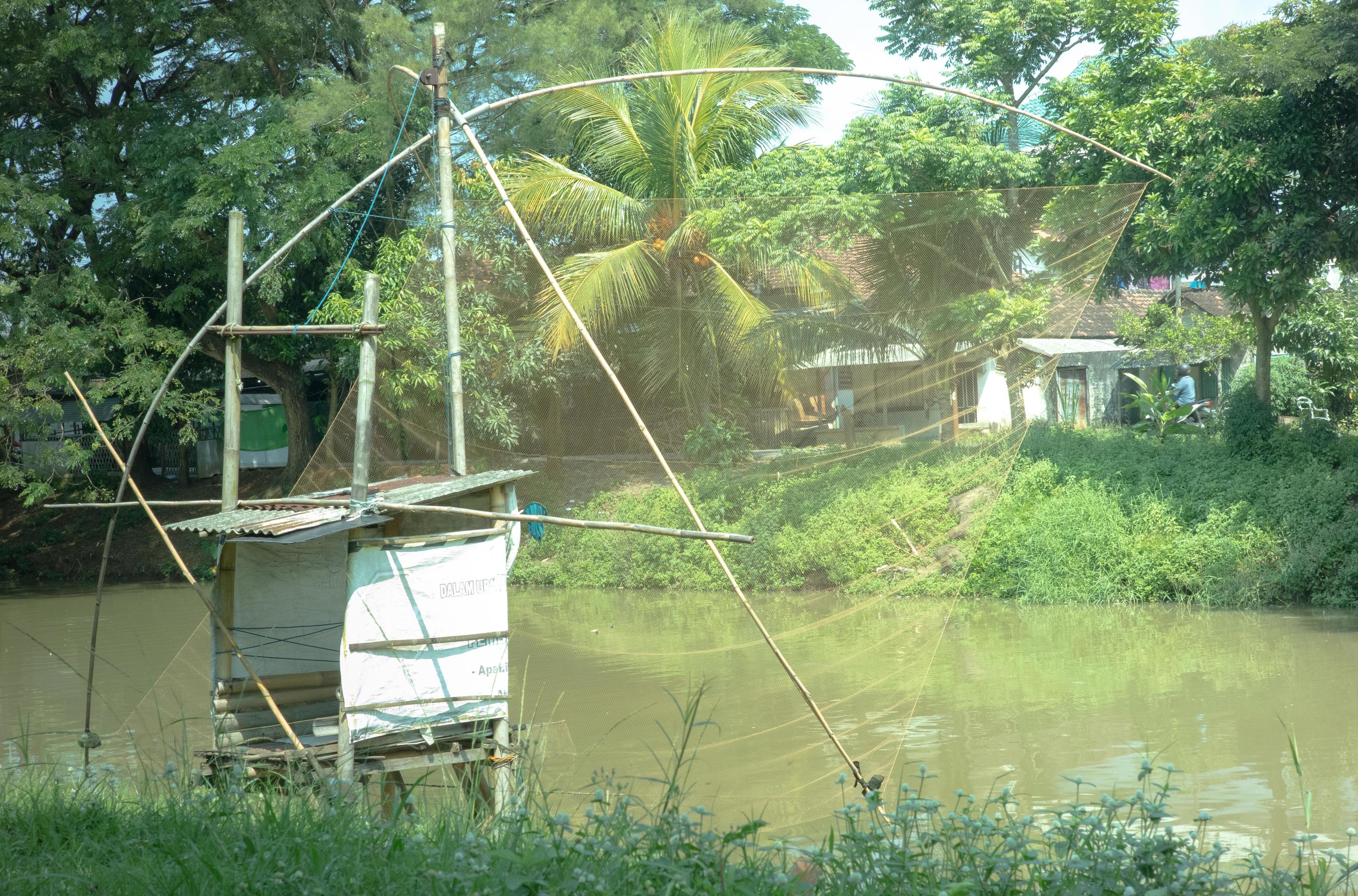 traditional tool for trapping fish by the river 7707717 Stock Photo at