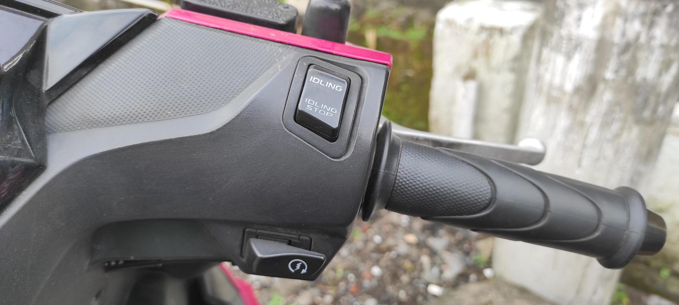 motorcycle start button and idling stop indicator photo
