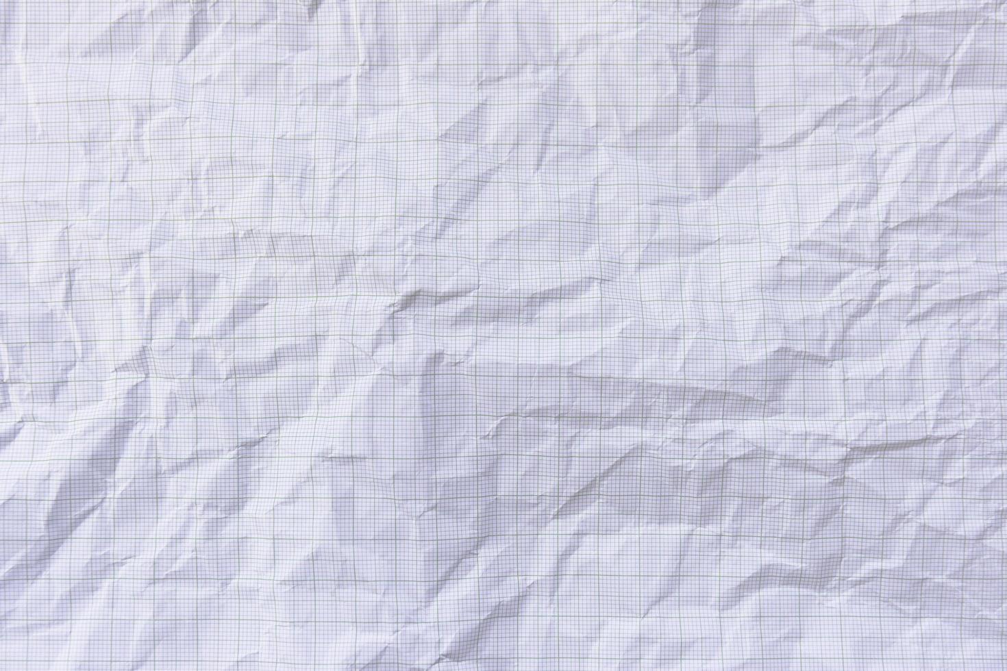 Square crumpled square graph paper on the background. photo