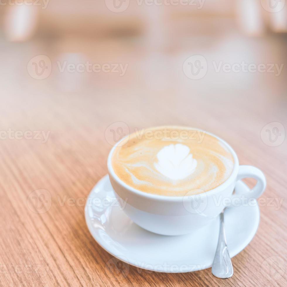 Hot coffee cup on wood table. photo