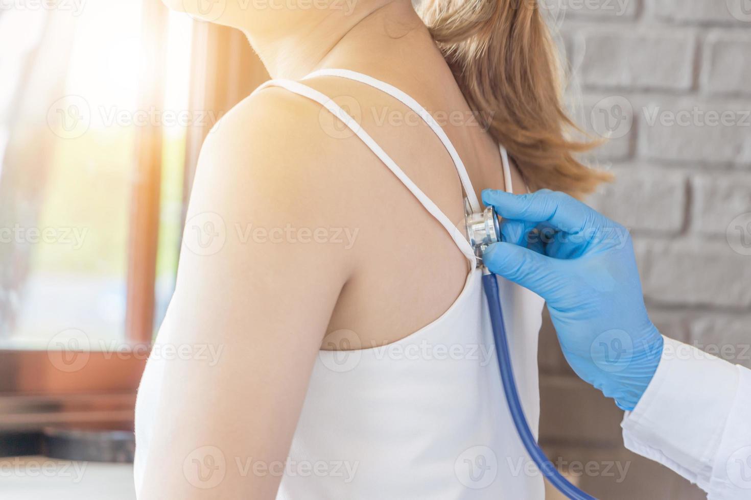 Young woman at clinic and doctor health check using stethoscope, Heathcare and medicineconcept photo