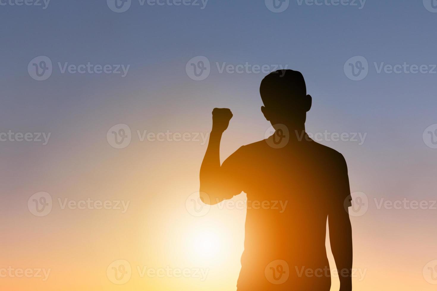 Silhouettes of Man Celebration Success Happiness Evening Sky Sunset Background, Sport and active life Concept. photo