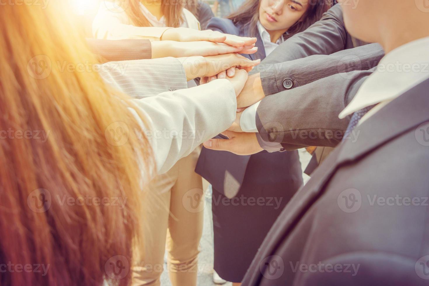 Success Teamwork Concept, Business people team joining hands outside office city background. photo