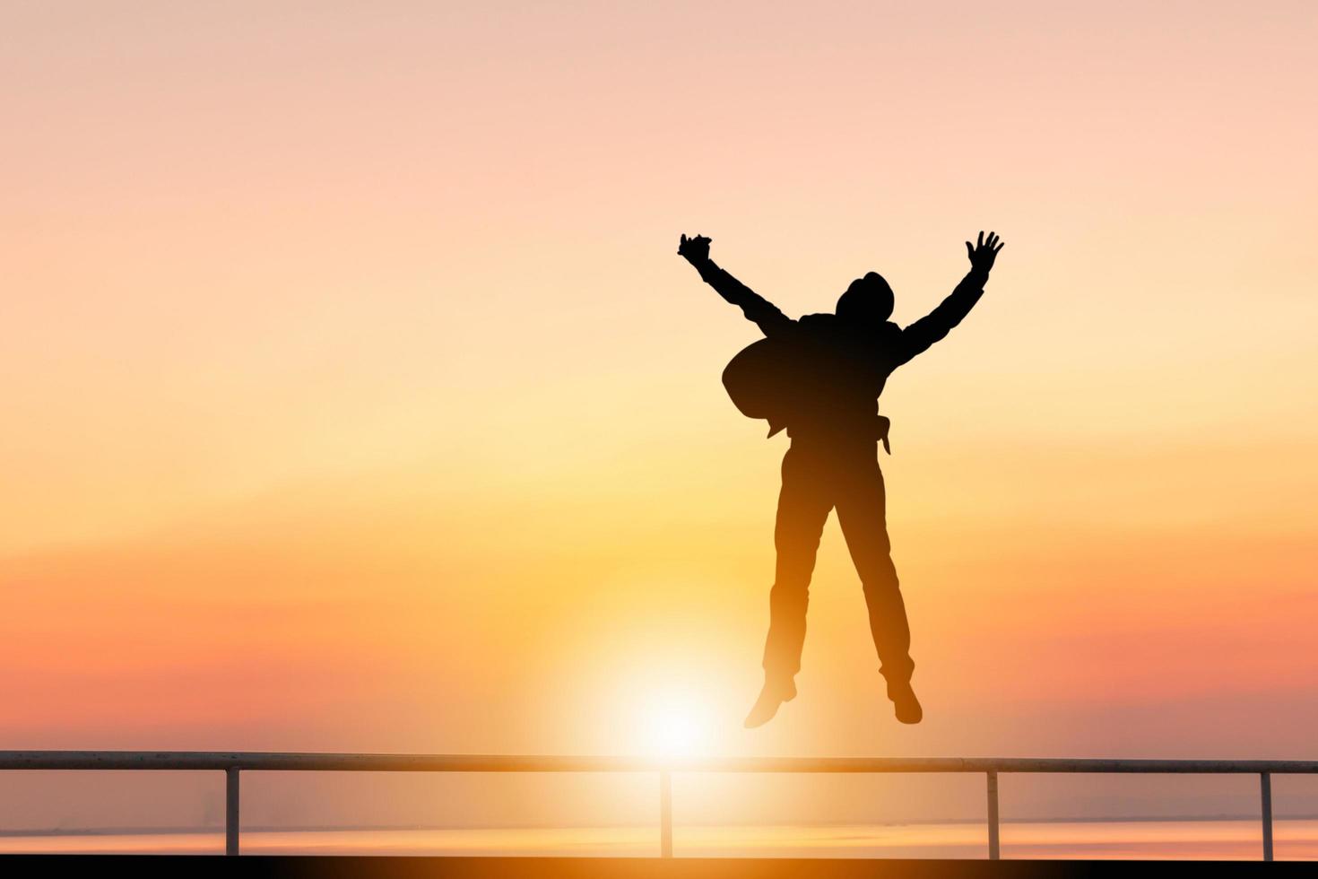 Silhouette of Business man Celebration Success Happiness Sunset Evening Sky Background, Successful and active life Concept. photo