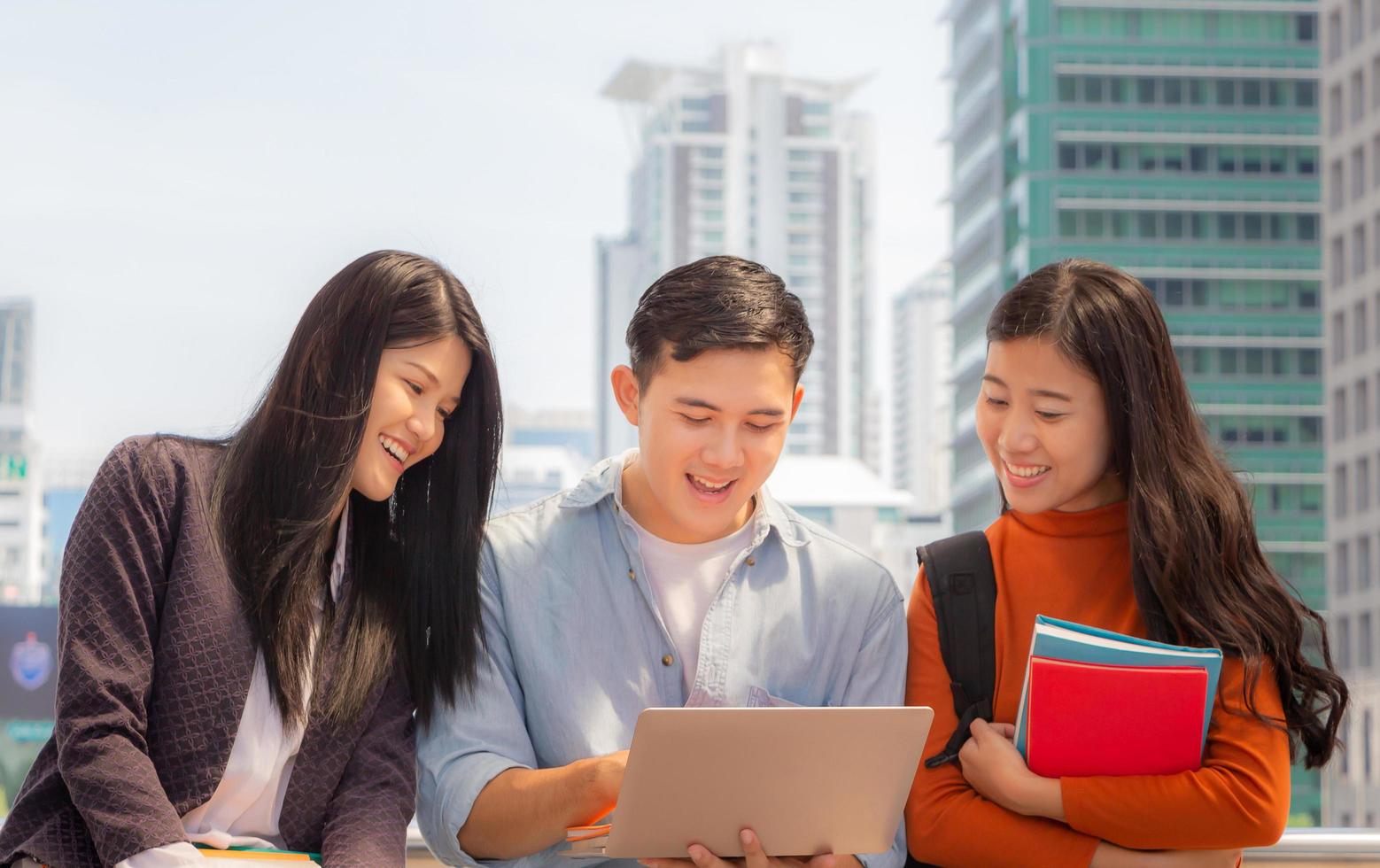 Close up of Happy high school students group are in attending of tutorial with notebook on the stair, education concept. photo