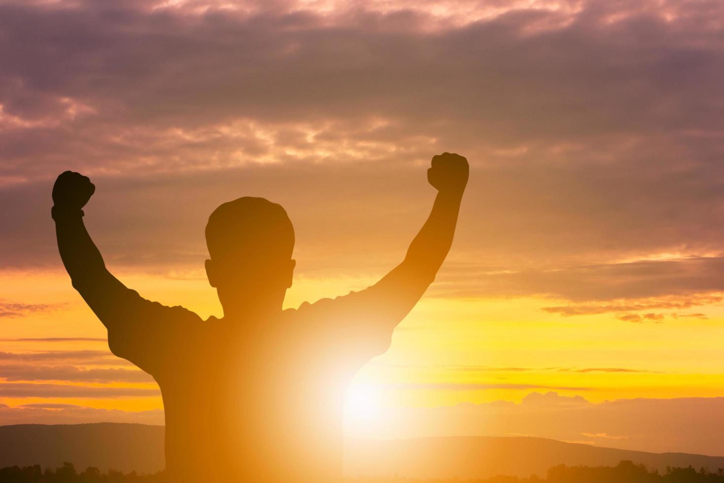 Silhouettes of Man Celebration Success Happiness Evening Sky Sunset Background, Sport and active life Concept. photo