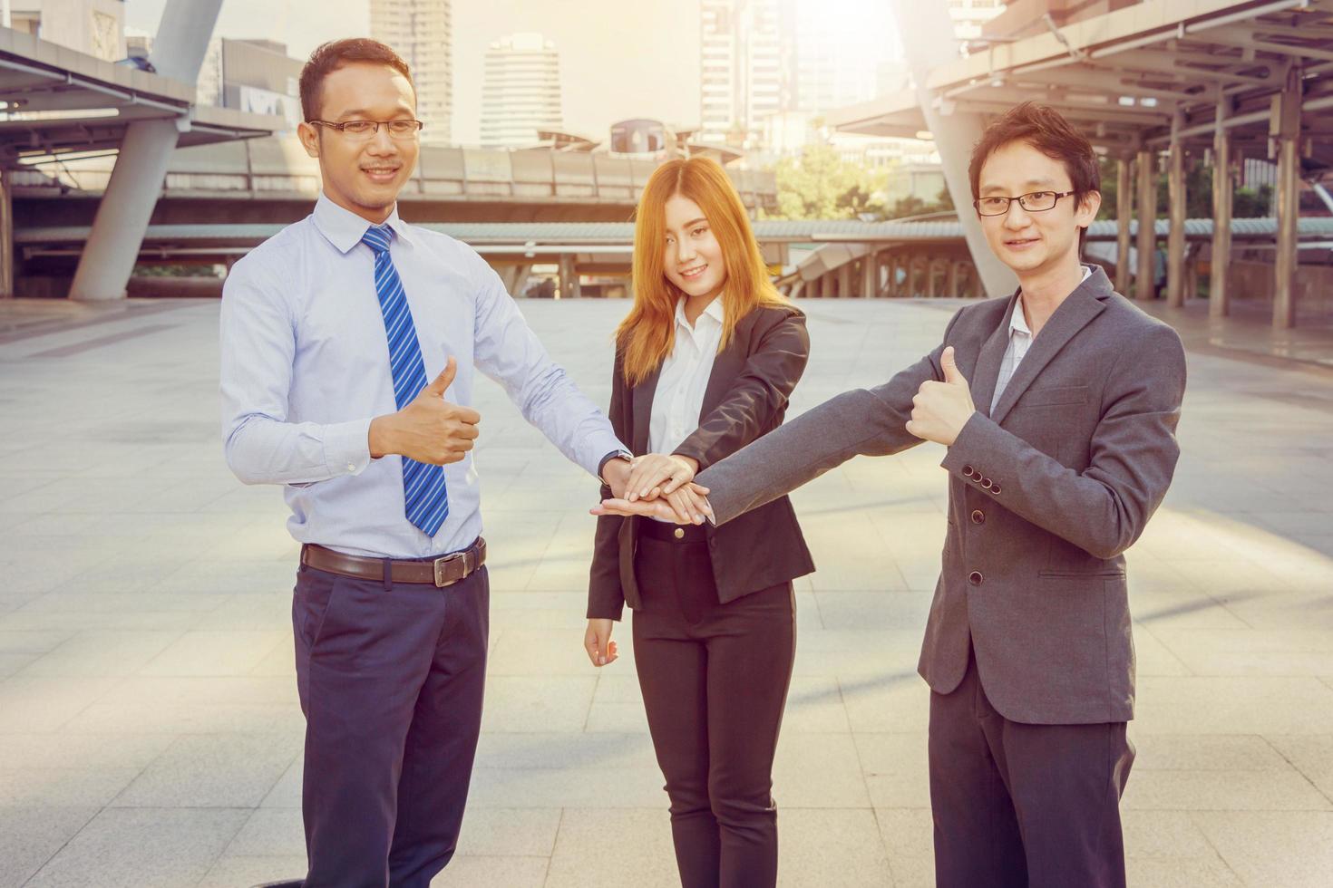 Business people team joined hands and showing thumbs up photo