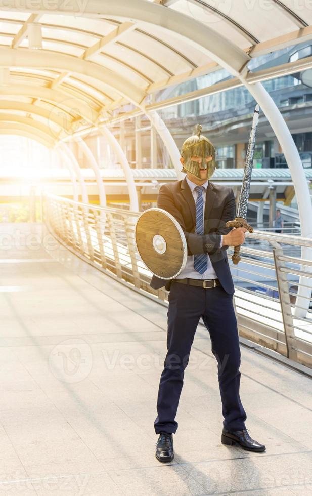 Business man knight holding a sword and shield photo
