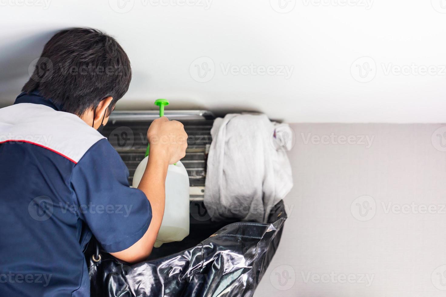 Repairman washing dirty compartments air conditioner, Male technician cleaning air conditioner indoors, Maintenance and repairing concepts photo