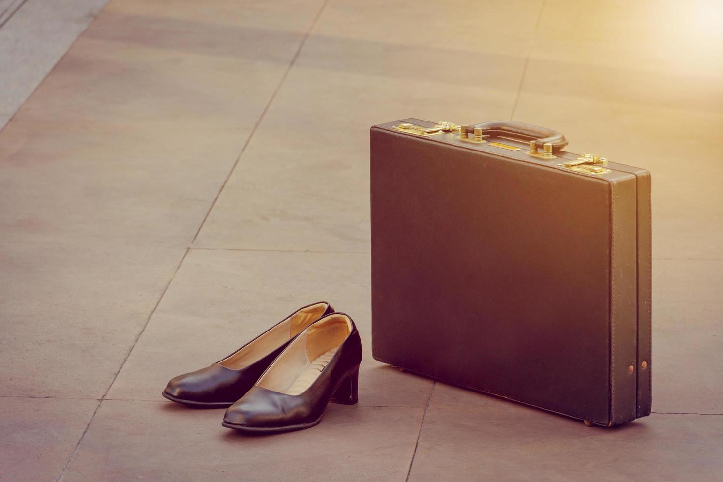 Woman shoes and black leather briefcase on floor, Business concept. photo