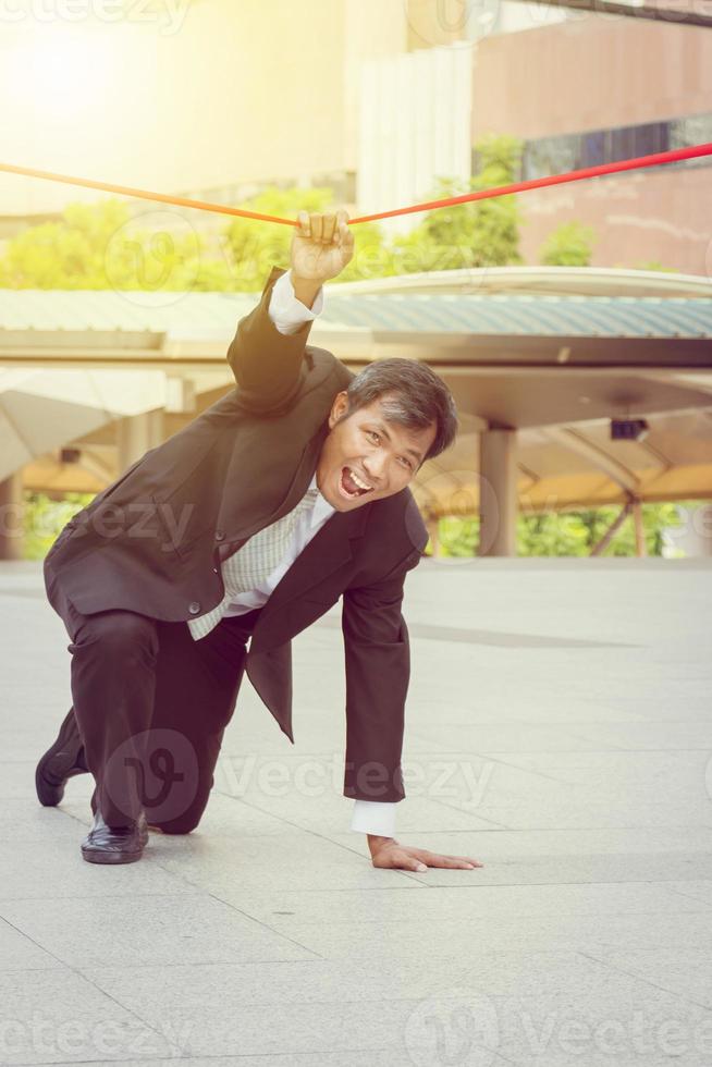 businessman crossing the finish line of racing track photo