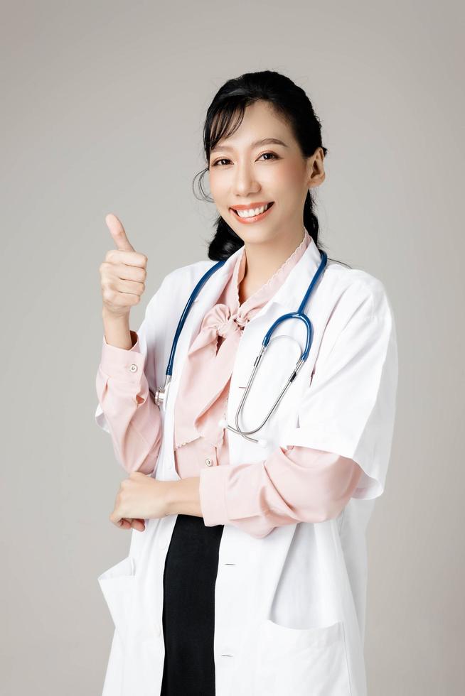 Portrait of an attractive young female doctor in white coat. photo