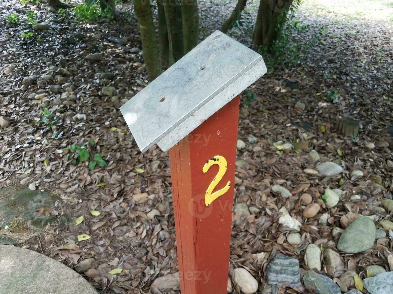 number 2 sign with surface on wood post on miniature golf course photo