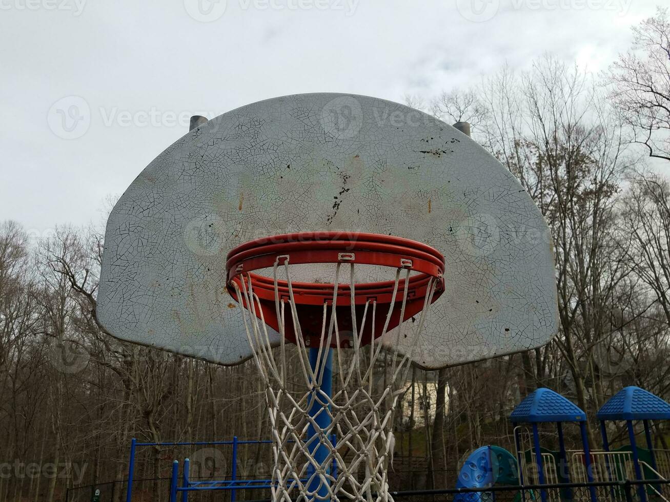 worn or weathered basketball hoop and backboard photo