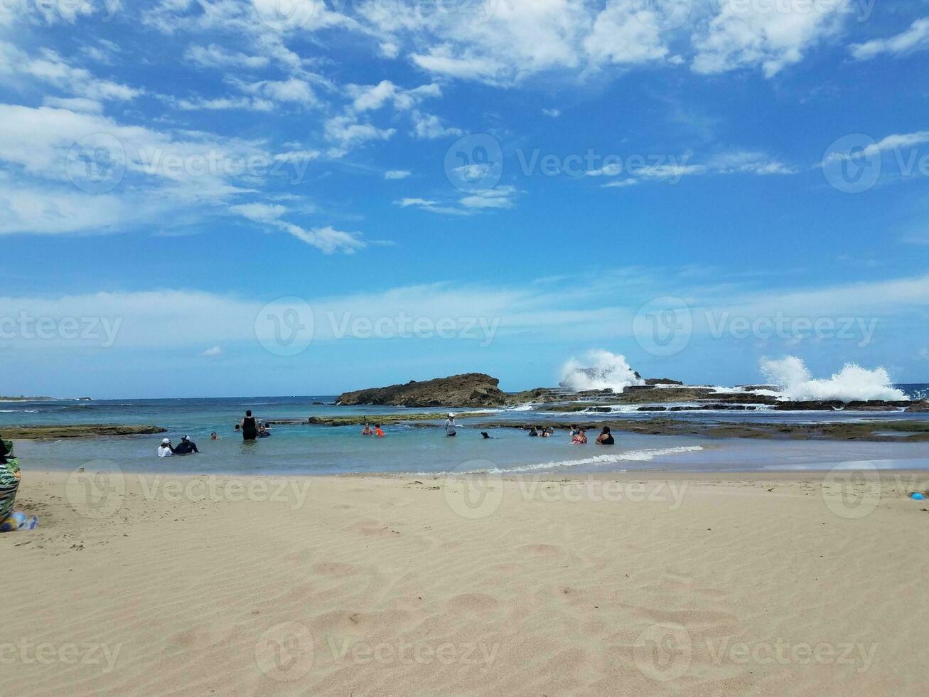 beach with sand in Isabela Puerto Rico with people in water photo