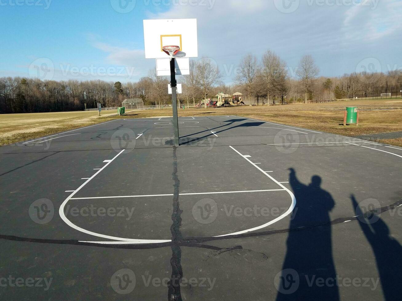 father and son shadows on basketball court photo