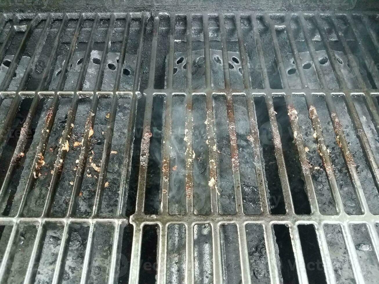 dirty or filthy bars on barbecue grill wih smoke photo