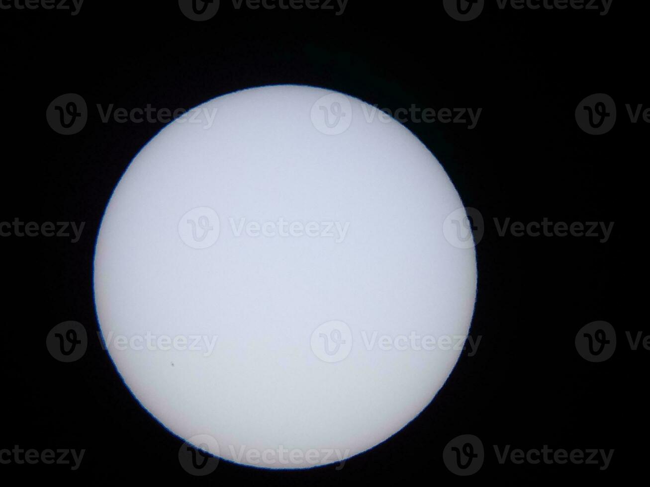 the sun viewed through a solar filter in a telescope photo