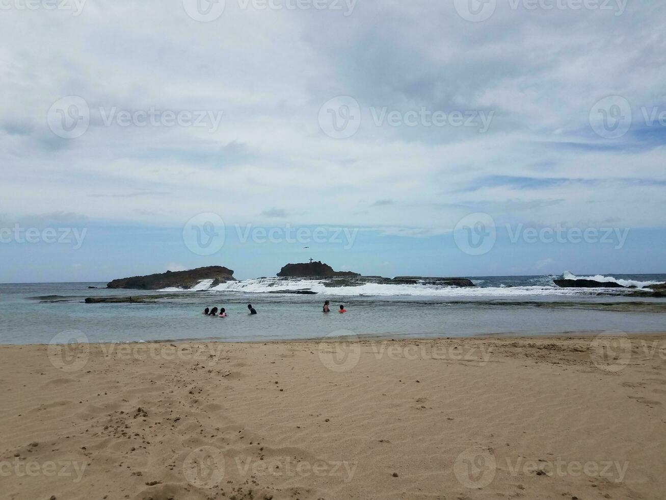 beach with sand in Isabela Puerto Rico with people in water photo