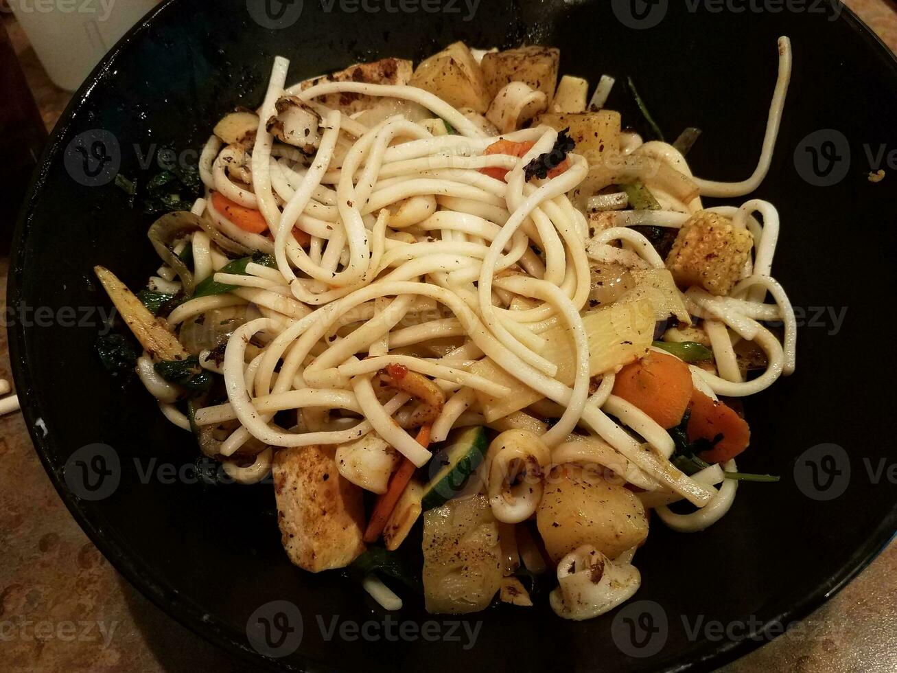 asian noodles and squid and pineapple in bowl photo