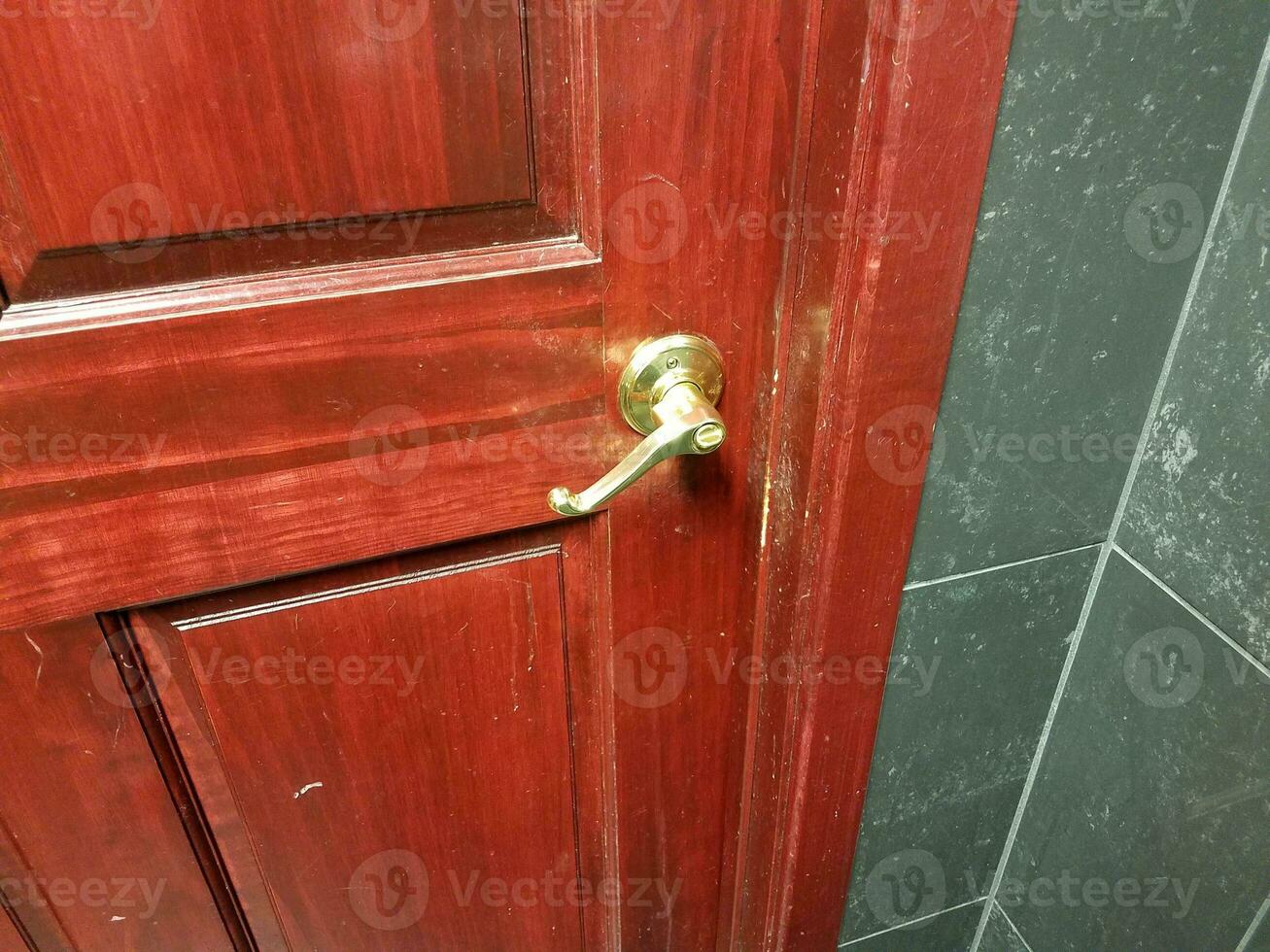 dark brown and red door with handle in bathroom photo