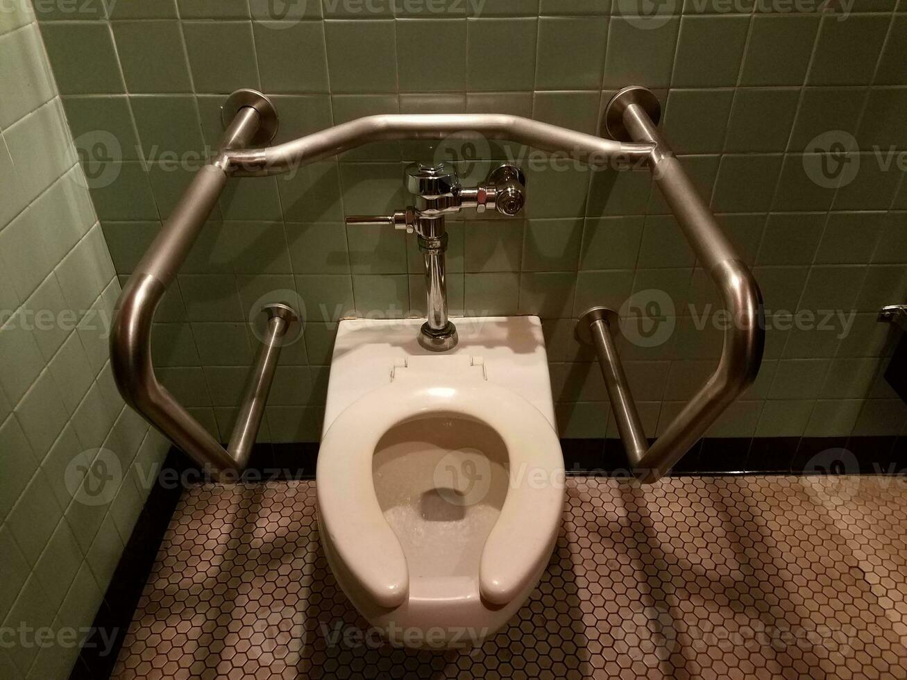 bathroom toilet with rails for gripping photo