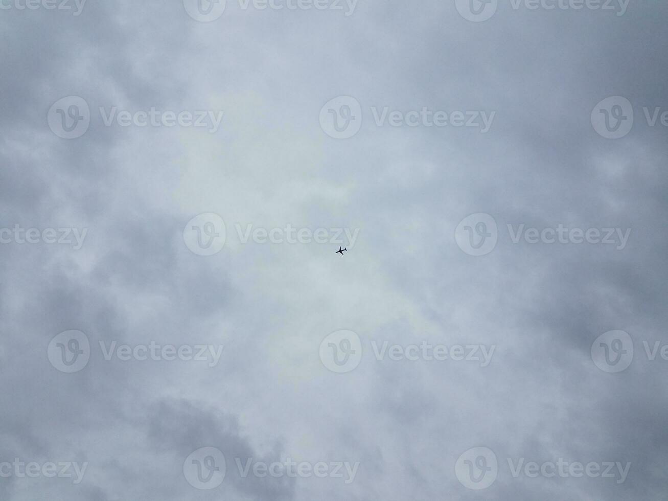 airplane or plane flying in the sky with clouds photo