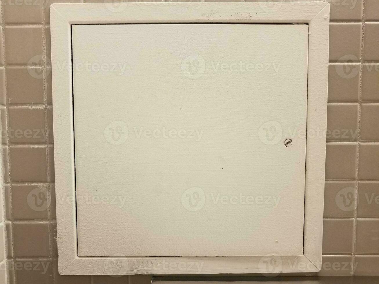 white door or panel on grey tiles in bathroom photo